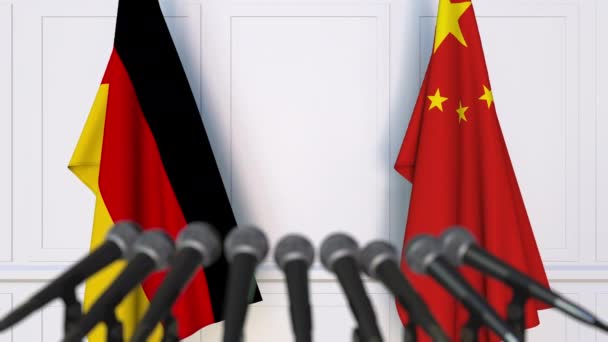 Flags of Germany and China at international meeting or negotiations press conference — Stock Video