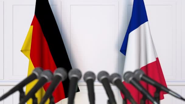 Flags of Germany and France at international meeting or negotiations press conference — Stock Video