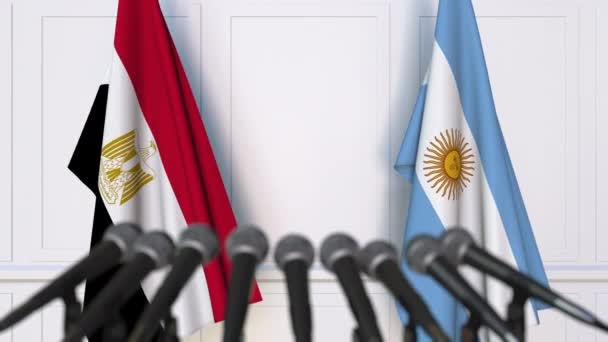 Flags of Egypt and Argentina at international meeting or negotiations press conference — Stock Video