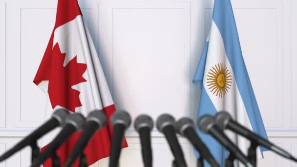 Flags of Canada and Argentina at international meeting or negotiations press conference — Stock Video