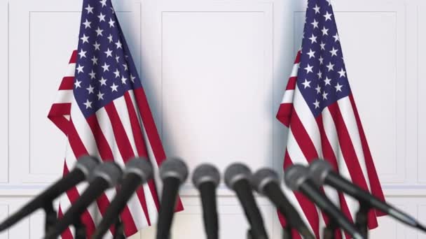 American official press conference. Flags of the United States and microphones. Conceptual animation — Stock Video