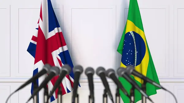 Флаги Великобритании и Бразилии на международной встрече или конференции. 3D рендеринг — стоковое фото