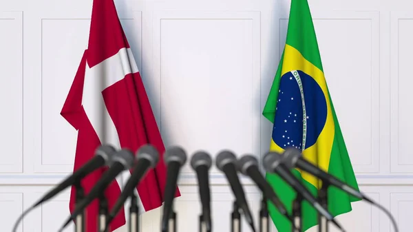 Флаги Дании и Бразилии на международной встрече или конференции. 3D рендеринг — стоковое фото