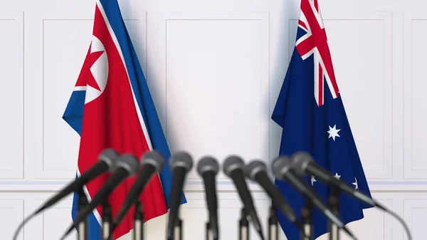 Flaggor av Nordkorea och Australien på internationellt möte eller konferens. 3D-rendering — Stockfoto