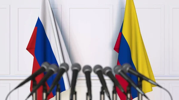 Bandeiras da Rússia e da Colômbia em reunião ou conferência internacional. Renderização 3D — Fotografia de Stock
