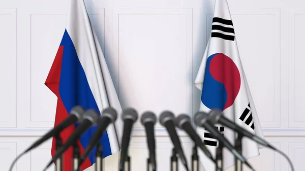 Bandeiras da Rússia e da Coreia em reunião ou conferência internacional. Renderização 3D — Fotografia de Stock