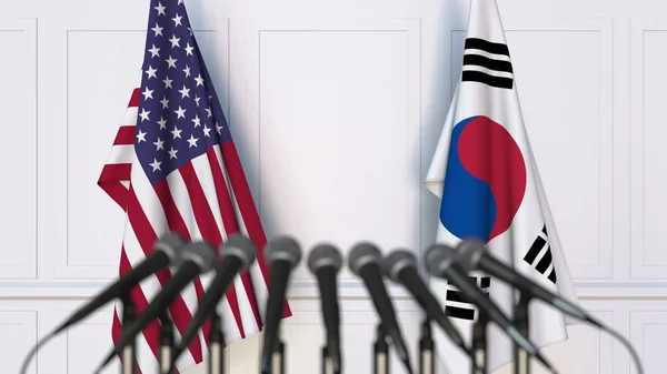 Banderas de los Estados Unidos y Corea en una reunión o conferencia internacional. Renderizado 3D — Foto de Stock