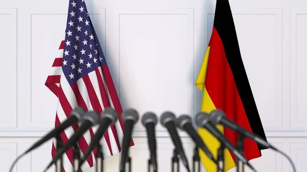 Bendera Amerika Serikat dan Jerman pada pertemuan atau konferensi internasional. Perender 3D — Stok Foto