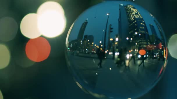 City downtown street crosswalk in the evening as seen through the glass ball — Stock Video