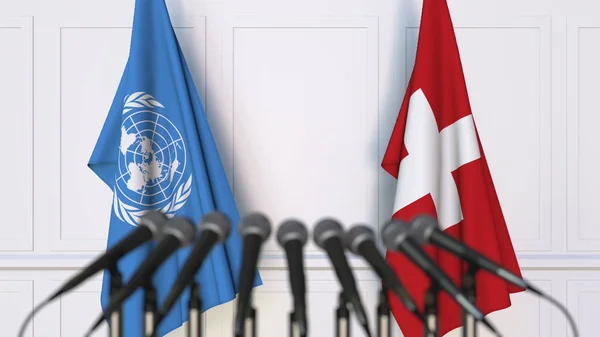 Flags of the United Nations and Switzerland at international meeting or conference. Editorial 3D rendering — Stock Photo, Image