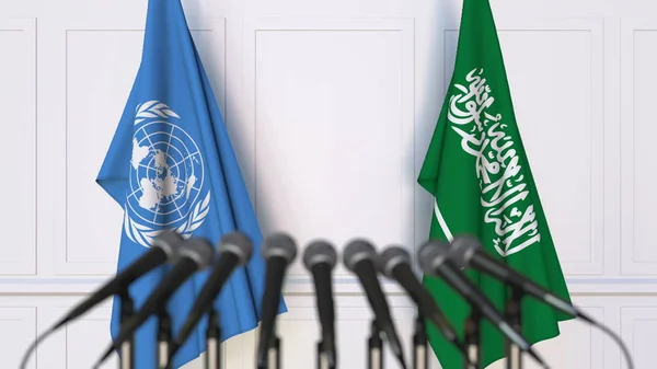 联合国和沙特阿拉伯在国际会议或会议上的旗帜。编辑3d 渲染 — 图库照片