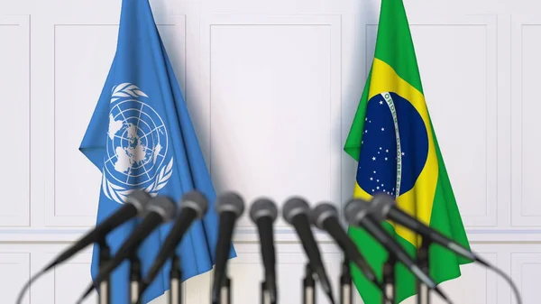 Флаги ООН и Бразилии на международной встрече или конференции. Редакционная 3D рендеринг — стоковое фото