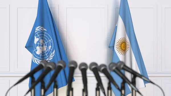 Flaggor av Förenta nationerna och Argentina på internationellt möte eller konferens. Redaktionella 3d-rendering — Stockfoto