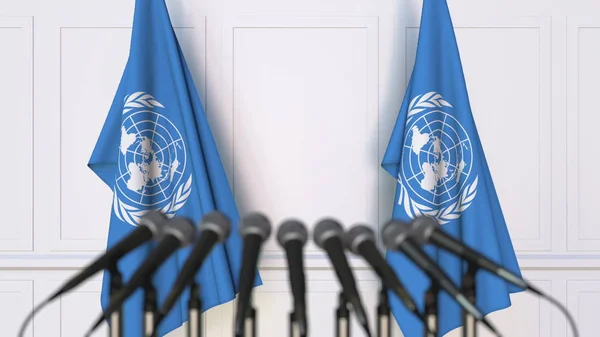 Conferencia de prensa oficial de las Naciones Unidas. Banderas de la ONU y micrófonos. Conceptual editorial 3D rendering — Foto de Stock