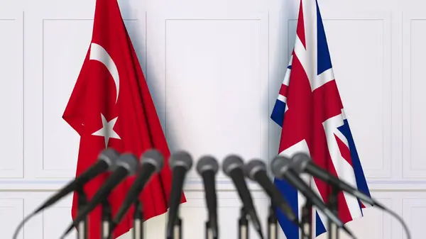 Bandiere della Turchia e del Regno Unito in occasione di riunioni o conferenze internazionali. Rendering 3D — Foto Stock