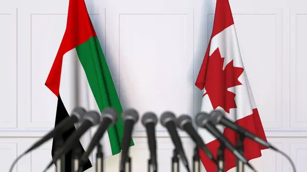 Drapeaux des Émirats arabes unis et du Canada lors d'une réunion ou d'une conférence internationale. rendu 3D — Photo