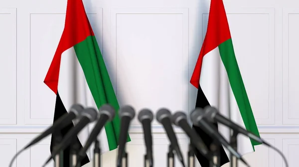 Official press conference. Flags of the United Arab Emirates UAE and microphones. Conceptual 3D rendering — Stock Photo, Image