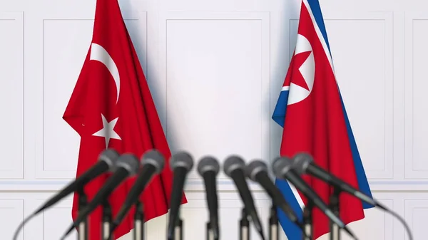 Türkiye ve Kuzey Kore bayrakları Uluslararası Toplantı veya konferans. 3D render — Stok fotoğraf