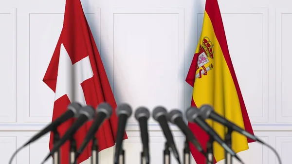 Bandiere della Svizzera e della Spagna in occasione di riunioni o conferenze internazionali. Rendering 3D — Foto Stock