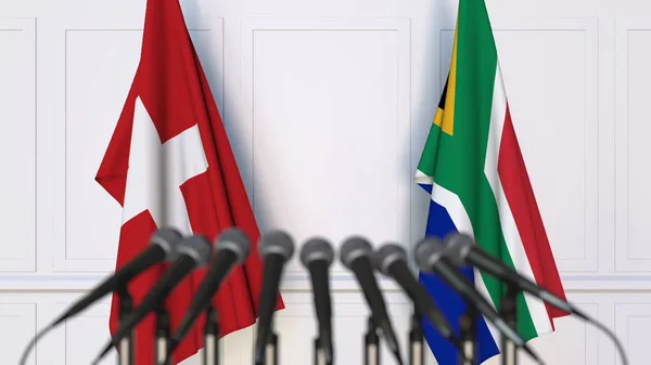 Drapeaux de la Suisse et de l'Afrique du Sud lors d'une réunion ou conférence internationale. rendu 3D — Photo