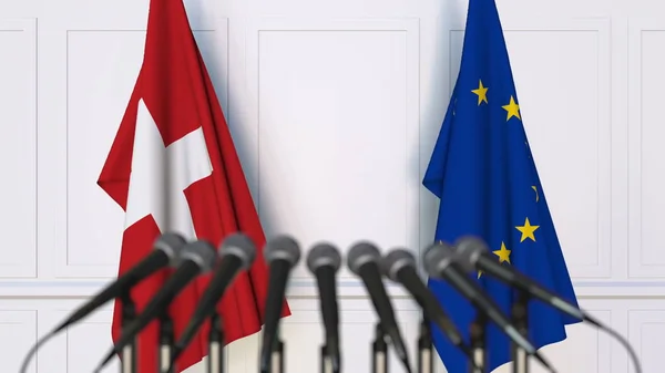 Banderas de Suiza y de la Unión Europea en reuniones o conferencias internacionales. Renderizado 3D — Foto de Stock