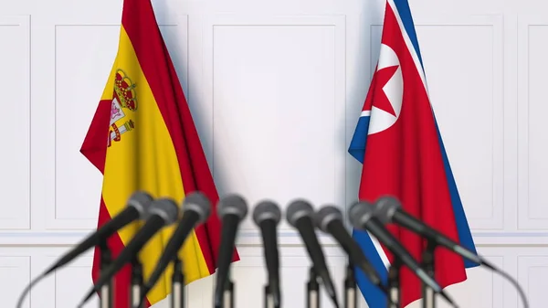 西班牙和北朝鲜在国际会议或会议上的旗帜。3d 渲染 — 图库照片