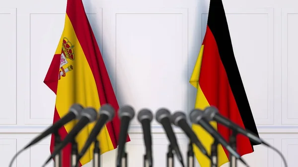 Bandiere di Spagna e Germania in occasione di riunioni o conferenze internazionali. Rendering 3D — Foto Stock