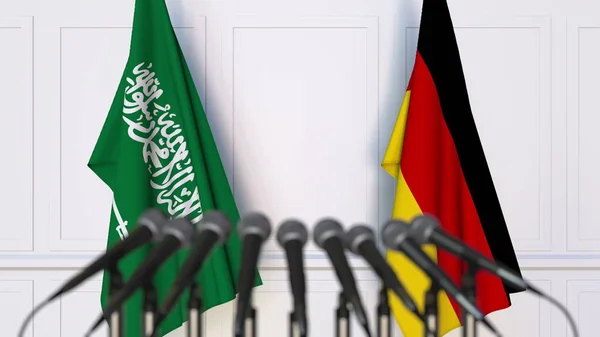 Bendera Arab Saudi dan Jerman pada pertemuan atau konferensi internasional. Perender 3D — Stok Foto