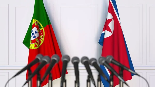 Bandeiras de Portugal e da Coreia do Norte em reunião ou conferência internacional. Renderização 3D — Fotografia de Stock