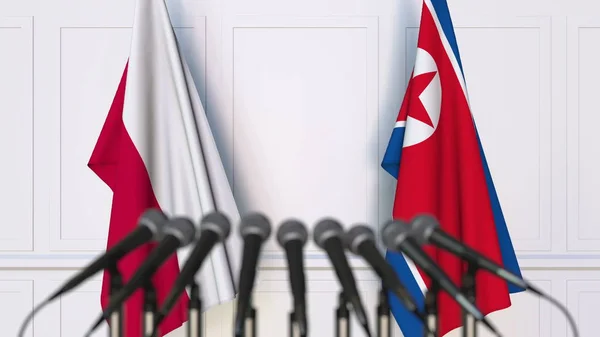 Drapeaux de la Pologne et de la Corée du Nord lors d'une réunion ou conférence internationale. rendu 3D — Photo