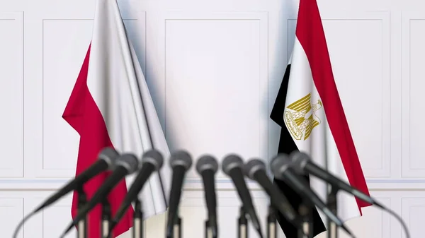 Bendera Polandia dan Mesir pada pertemuan atau konferensi internasional. Perender 3D — Stok Foto