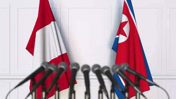Bandeiras do Peru e da Coreia do Norte em reunião ou conferência internacional. Renderização 3D — Fotografia de Stock
