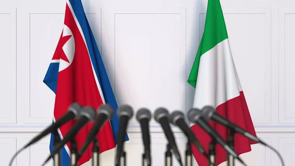 Flaggen Nordkoreas und Italiens bei internationalen Treffen oder Konferenzen. 3D-Darstellung — Stockfoto