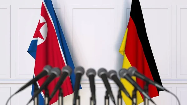 Drapeaux de la Corée du Nord et de l'Allemagne lors d'une réunion ou conférence internationale. rendu 3D — Photo