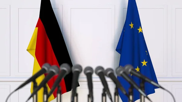 Drapeaux de l'Allemagne et de l'Union européenne lors d'une réunion ou d'une conférence internationale. rendu 3D — Photo