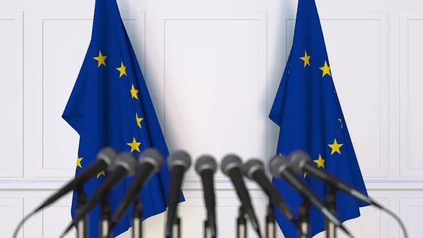 Conferencia de prensa oficial. Banderas de la Unión Europea UE y micrófonos. Renderizado 3D conceptual —  Fotos de Stock