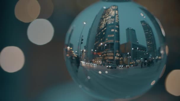 City street crosswalk in the evening, view through the glass ball — Stock Video