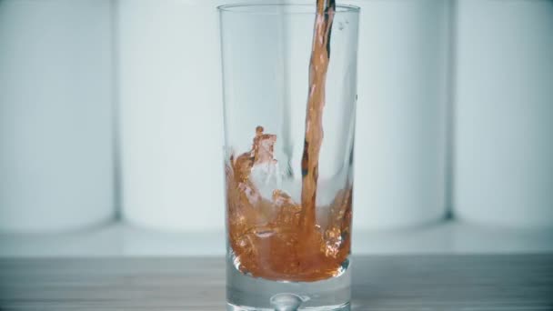 Pouring juice into glass, super slow motion shot — Stock Video