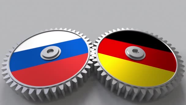Флаги России и Германии на сетчатых передачах. Концептуальная анимация международного сотрудничества — стоковое видео