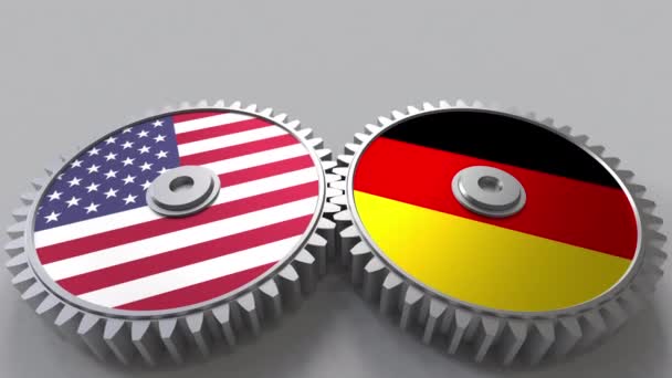 Vlaggen van de VS en Duitsland op het weven van de versnellingen. Internationale samenwerking conceptuele animatie — Stockvideo