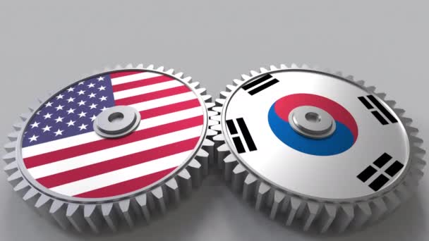 Bandiere degli Stati Uniti e della Corea su ingranaggi a maglie. Cooperazione internazionale animazione concettuale — Video Stock