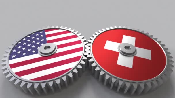 歯車のかみあいに米国およびスイス連邦共和国のフラグです。国際協力の概念のアニメーション — ストック動画