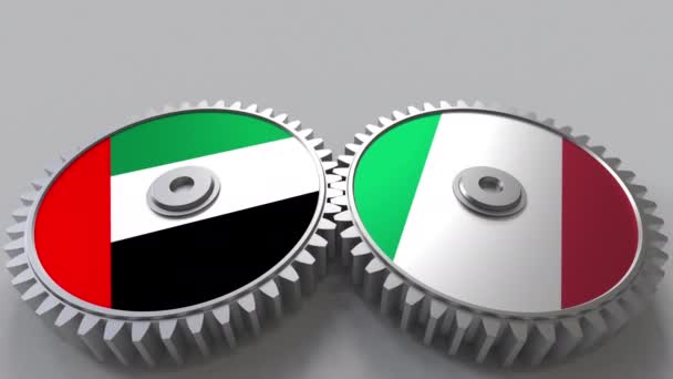 Banderas de los Emiratos Árabes Unidos e Italia en engranajes de malla. Cooperación internacional animación conceptual — Vídeos de Stock