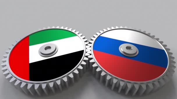 Bandiere degli Emirati Arabi Uniti e della Russia su ingranaggi a maglie. Cooperazione internazionale animazione concettuale — Video Stock