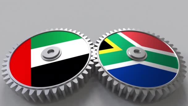 Flaggor i Förenade Arabemiraten och Sydafrika på Meshning gears. Internationellt samarbete konceptuella animation — Stockvideo