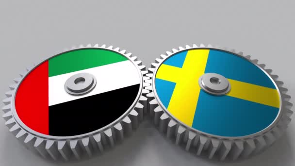 Banderas de los Emiratos Árabes Unidos y Suecia en engranajes de malla. Cooperación internacional animación conceptual — Vídeo de stock