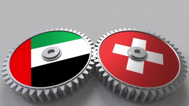 Bandiere degli Emirati Arabi Uniti e della Svizzera sugli ingranaggi a maglie. Cooperazione internazionale animazione concettuale — Video Stock