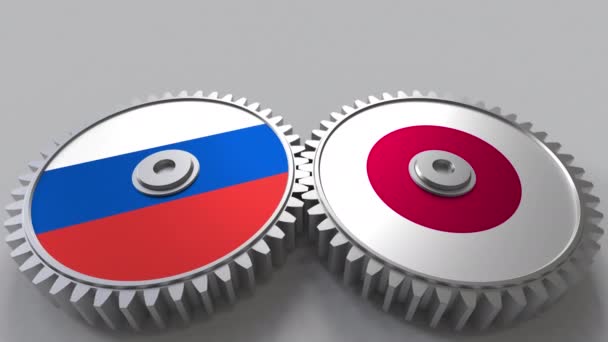 Flaggen Russlands und Japans auf verzahnten Zahnrädern. Konzeptionelle Animation der internationalen Zusammenarbeit — Stockvideo