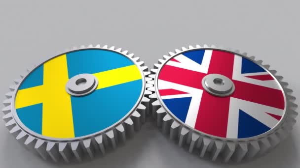Vlajky Švédska a Spojeného království o záběru ozubených kol. Mezinárodní spolupráce koncepční animace — Stock video