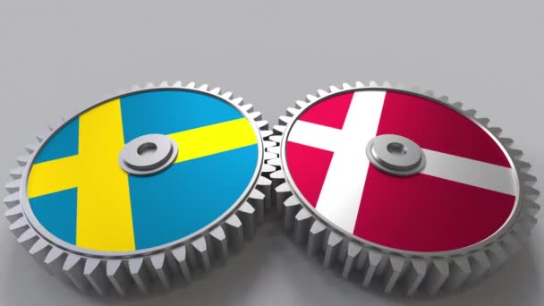 Flags of Sweden and Denmark on meshing gears. International cooperation conceptual animation — Stock Video